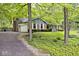Landscaped front yard and lush surroundings compliment this brick and siding home with attached garage at 19446 Ethan Allen Ln, Westfield, IN 46074