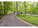 Long driveway leading to a charming brick and siding house surrounded by mature trees and landscaping at 19446 Ethan Allen Ln, Westfield, IN 46074