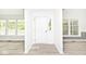 Bright foyer with gray wood-look floors, white walls, and natural light flooding through the adjacent rooms' windows at 19446 Ethan Allen Ln, Westfield, IN 46074