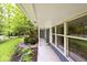 Covered front porch featuring blue siding, white trim, and a well-maintained garden with various plants at 19446 Ethan Allen Ln, Westfield, IN 46074