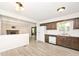 Open-concept kitchen with wooden cabinetry, stainless appliances, and easy access to the living room at 19446 Ethan Allen Ln, Westfield, IN 46074