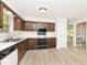 Traditional eat-in kitchen featuring wood cabinets, modern appliances, and plank flooring at 19446 Ethan Allen Ln, Westfield, IN 46074