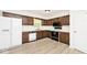Functional kitchen with wood cabinets, white appliances, and modern flooring for a clean and updated look at 19446 Ethan Allen Ln, Westfield, IN 46074