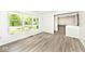 Open living space featuring wood-look floors, a large window, and seamless transition to other rooms at 19446 Ethan Allen Ln, Westfield, IN 46074