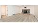 Open living room with a brick fireplace, plank flooring, and natural light at 19446 Ethan Allen Ln, Westfield, IN 46074