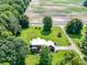 Aerial view showing the house on the property, surrounded by lush green lawns at 19702 Centennial Rd, Sheridan, IN 46069