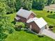 Aerial view of the home and detached garage, set among lush greenery at 19702 Centennial Rd, Sheridan, IN 46069