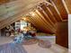 Attic featuring exposed wooden beams and a collection of items and furniture, offering versatile storage space at 19702 Centennial Rd, Sheridan, IN 46069