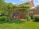 Secluded backyard features a charming pergola with swing and views of the beautiful brick home at 19702 Centennial Rd, Sheridan, IN 46069