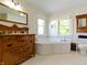 Bright bathroom featuring a garden tub, vanity with storage, and natural light at 19702 Centennial Rd, Sheridan, IN 46069