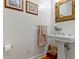 Classic bathroom with a pedestal sink, decorative mirror, and vintage charm at 19702 Centennial Rd, Sheridan, IN 46069