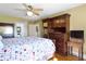 This bedroom features a decorative quilt, ceiling fan, lots of storage, and natural light at 19702 Centennial Rd, Sheridan, IN 46069