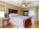Comfortable bedroom featuring ceiling fan, adjacent bathroom, and sunny window at 19702 Centennial Rd, Sheridan, IN 46069