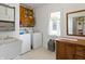 Convenient laundry room with washer, dryer, sink, and storage cabinets at 19702 Centennial Rd, Sheridan, IN 46069