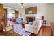 Cozy living room featuring a brick fireplace, hardwood floors, and comfortable seating arrangement at 19702 Centennial Rd, Sheridan, IN 46069