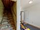 Unfinished stairway, adjacent to a home gym, showcases renovation potential and utility at 19702 Centennial Rd, Sheridan, IN 46069