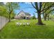 Spacious backyard with green grass, seating area and view of house at 20400 Chatham Hills Blvd, Westfield, IN 46074