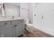 Modern bathroom with gray vanity, quartz countertop, and glass-enclosed shower with subway tile surround at 20400 Chatham Hills Blvd, Westfield, IN 46074