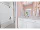 White bathroom features white subway tiles, a bathtub, and a vanity with a mirror at 20400 Chatham Hills Blvd, Westfield, IN 46074