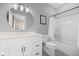 Well-lit bathroom featuring a modern vanity, round mirror, and a shower-tub combo with white tile surround at 20400 Chatham Hills Blvd, Westfield, IN 46074
