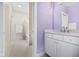 Purple bathroom featuring white tiles, a bathtub and shower combination, and white vanity at 20400 Chatham Hills Blvd, Westfield, IN 46074