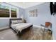 Comfortable bedroom with ample natural light, stylish decor, and wood-look flooring for a relaxing ambiance at 20400 Chatham Hills Blvd, Westfield, IN 46074