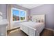 Bedroom with light purple walls featuring hardwood floors and an exterior view at 20400 Chatham Hills Blvd, Westfield, IN 46074