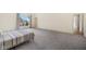 Bedroom featuring grey carpet, a large window with blinds, and a partial bed at 20400 Chatham Hills Blvd, Westfield, IN 46074