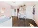 Pink bedroom with trophy display shelves, a white desk, and hardwood flooring at 20400 Chatham Hills Blvd, Westfield, IN 46074
