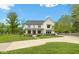 Beautiful two-story home with green lawn and concrete driveway on a sunny day at 20400 Chatham Hills Blvd, Westfield, IN 46074