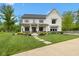 Charming two-story home with black accents, manicured lawn, and inviting front porch seating at 20400 Chatham Hills Blvd, Westfield, IN 46074