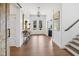 Elegant foyer with hardwood floors, staircase, console table, and natural light at 20400 Chatham Hills Blvd, Westfield, IN 46074