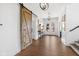 Inviting foyer showcasing wood floors, decorative accents, and barn-style door at 20400 Chatham Hills Blvd, Westfield, IN 46074