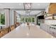 Bright kitchen island offers seating and open floor plan with dining area and outdoor views at 20400 Chatham Hills Blvd, Westfield, IN 46074