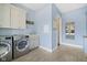 Well-equipped laundry room with modern washer and dryer, ample cabinet space, and stylish design at 20400 Chatham Hills Blvd, Westfield, IN 46074