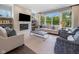Bright living room with a fireplace, large windows, and comfortable seating arrangements at 20400 Chatham Hills Blvd, Westfield, IN 46074