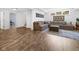 Cozy living room with a large sectional sofa, wood-look flooring, and a window providing natural light at 20400 Chatham Hills Blvd, Westfield, IN 46074
