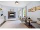 Comfortable sitting area features a tiled fireplace and natural light at 20400 Chatham Hills Blvd, Westfield, IN 46074