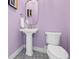 Stylish powder room features unique floor tiles, a pedestal sink, and modern fixtures at 20400 Chatham Hills Blvd, Westfield, IN 46074
