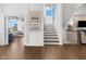 Elegant staircase with hardwood steps, natural light, and access to upper levels at 20400 Chatham Hills Blvd, Westfield, IN 46074