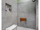 Modern bathroom featuring tiled shower with built-in shelf, shower chair, and folding wooden seat at 206 Cranberry Dr, Greenfield, IN 46140