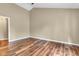 A spacious bedroom with hardwood floors and a neutral color scheme provides a blank canvas for personalization at 206 Cranberry Dr, Greenfield, IN 46140