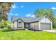 Charming home featuring a well-maintained lawn, stone accents, and an attached two-car garage at 206 Cranberry Dr, Greenfield, IN 46140