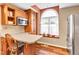 Bright kitchen with stainless steel appliances, eat-in countertop, and large arched window at 206 Cranberry Dr, Greenfield, IN 46140