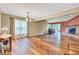 Spacious living room featuring hardwood floors, large window, fireplace, and neutral paint at 206 Cranberry Dr, Greenfield, IN 46140