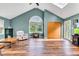 Vaulted living room with hardwood floors, large window, and neutral paint at 206 Cranberry Dr, Greenfield, IN 46140