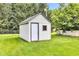 Backyard shed with a window and a white door on a green lawn at 206 Cranberry Dr, Greenfield, IN 46140