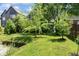 Lush green backyard with well-maintained lawn, trees, and landscaping, offering a serene outdoor space at 2134 N Alabama St, Indianapolis, IN 46202