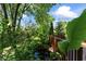 Backyard featuring a tranquil pond surrounded by lush greenery and a wooden deck with railings at 2134 N Alabama St, Indianapolis, IN 46202