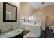 Modern bathroom featuring a soaking tub, decorative tile, and a glass bowl sink at 2134 N Alabama St, Indianapolis, IN 46202